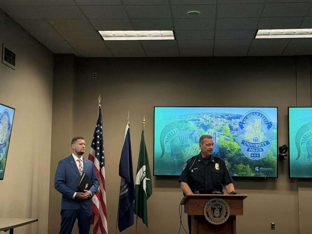 <p>Chief of Police and Executive Director of Public Safety at Michigan State University Mike Yankowski gives a speech with Detective Sergeant Aaron Schroeder standing on the left in East Lansing, Mich., on Friday, Sept. 11, 2026.</p>