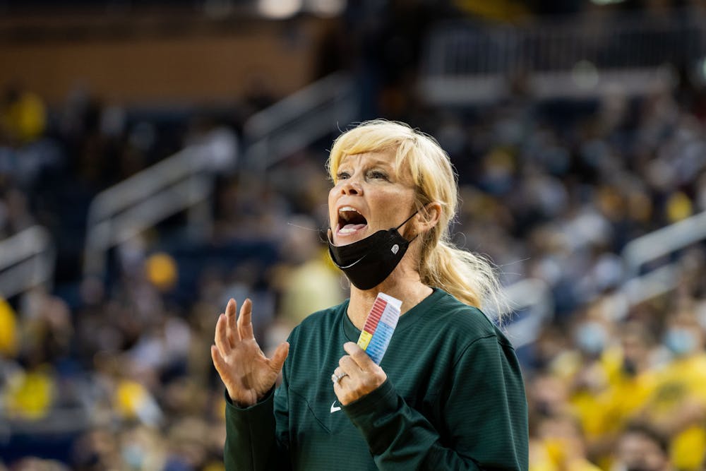 Head Coach Suzy Merchant coaches her team from the sidelines. The Wolverines defeated the Spartans 62-51 at the Crisler Center on Feb 24., 22.