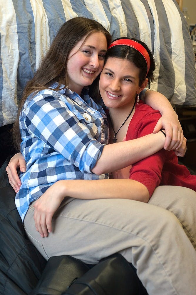 <p>Social relations & policy sophomore Nickle Trudeau and political theory & constitutional democracy junior Alyssa George pose for a portrait  Feb. 8, 2015, in Trudeau's dorm room in Case Hall. Trudeau and George have been dating for nine months. Emily Nagle/The State News</p>
