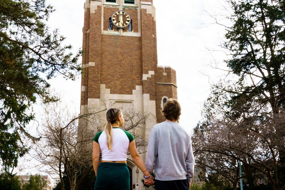 A couple standing in front of the Beaumont Tower on Michigan State University Campus, photgraphed on March 22, 2023.