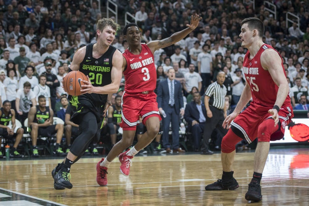 Senior guard Matt McQuaid (20) drives to the net during the men's basketball game against Ohio State at Breslin Center on Feb. 17, 2019. The Spartans defeated the Buckeyes, 62-44. Nic Antaya/The State News