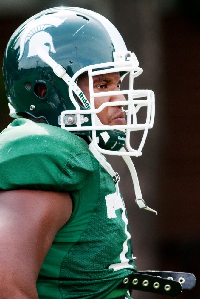 	<p>Senior offensive guard Arthur Ray Jr. pauses between drills in practice Tuesday on the outdoor practice field at the Duffy Daugherty Football Building.</p>