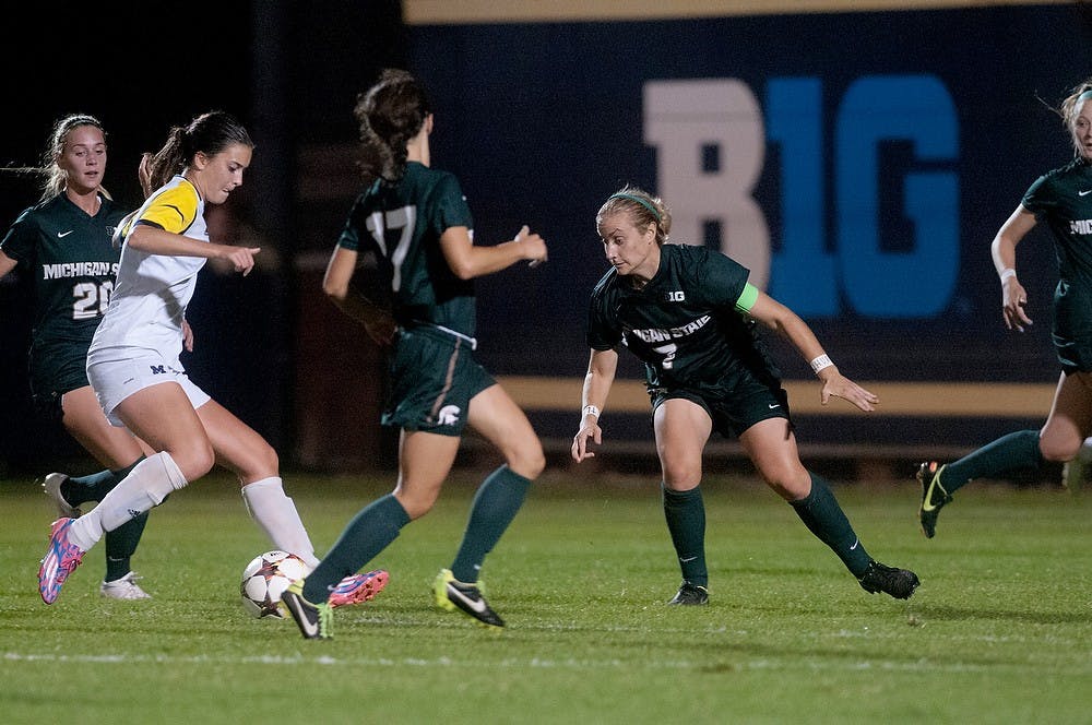 <p>Junior defender Mary Kathryn Fiebernitz, 7, looks to steal the ball from Michigan midfielder/forward Ani Sarkisian on Sept. 27, 2014 at the U-M Soccer Stadium in Ann Arbor, Mich. The Wolverines defeated the Spartans, 2-1. Jessalyn Tamez/The State News</p>