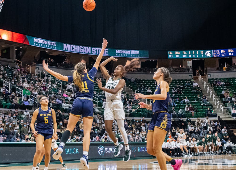 <p>Notre Dame&#x27;s Sonia Citron (11) attempts to block Nia Clouden&#x27;s (24) shot during Michigan State&#x27;s loss on Dec. 2, 2021.</p>