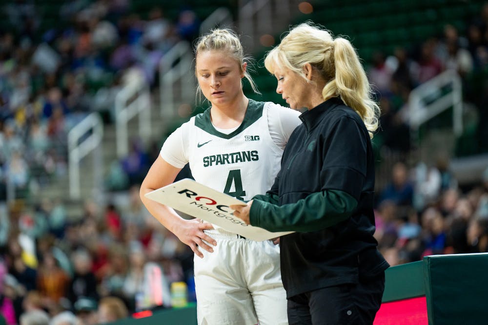 <p>Head coach Suzy Merchant speaks to freshman guard Theryn Hallock during the Spartans&#x27; 86-37 win over Delaware State on Nov. 7.</p>
