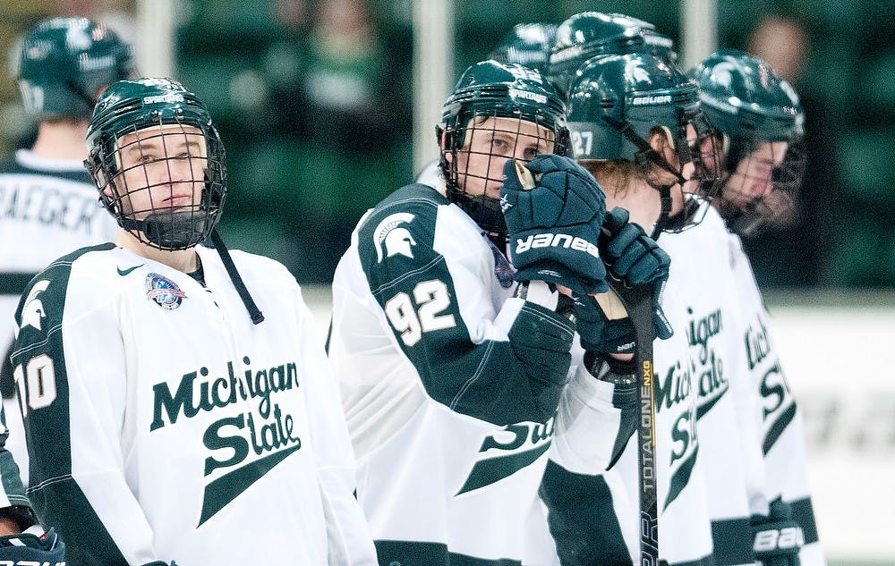 	<p>Spartan players including sophomore forward Tanner Sorenson, left, and freshman forward David Bondra, stand on the ice after losing the game against Ohio State, 3-1, Saturday, Dec. 1, 2012, at Munn Ice Arena. Justin Wan/The State News</p>