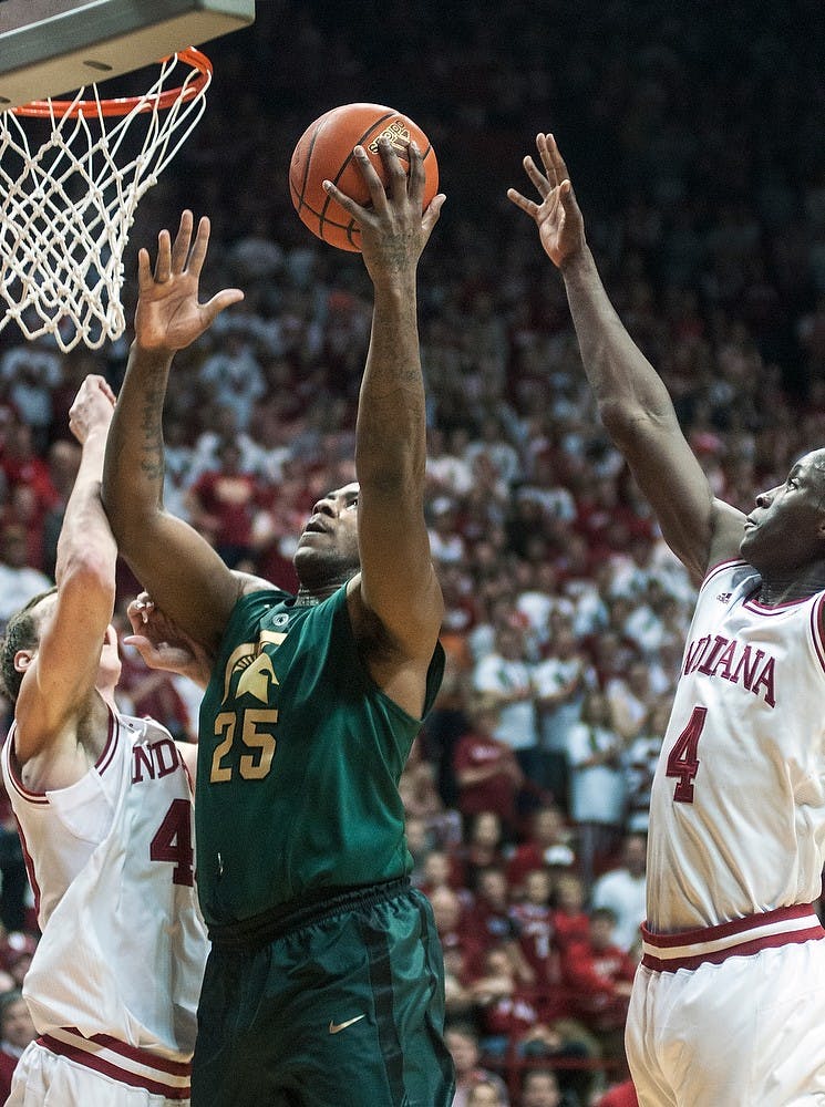 	<p>Senior center Derrick Nix attempts a shot underneath the basket as Indiana defenders try for a block Sunday, Jan. 27, 2013, at Assembly Hall in Bloomington, Ind. The Hoosiers defeated the Spartans, 75-70, giving <span class="caps">MSU</span> its second loss in the Big Ten. Adam Toolin/The State News</p>