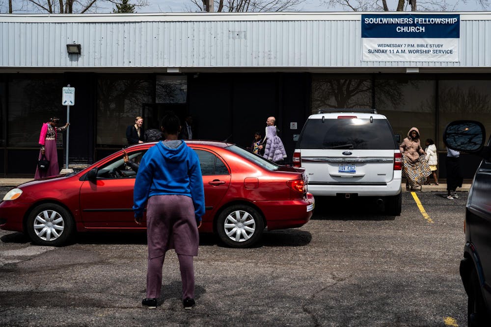 Pastor Michael Venyah departs Soulwinners Fellowship Church in a red car following a Sunday worship service in Lansing, Mich., on Sunday, April 12, 2026.