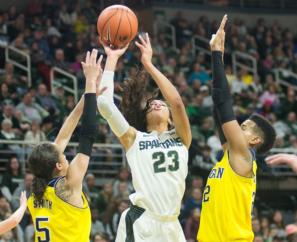 <p>Sophomore forward Aerial Powers attempts a point over Michigan guard Shannon Smith and forward Cyesha Goree Feb 5, 2015, during the game against Michigan at Breslin Center. The Spartans were defeated by the Wolverines, 72-59. Kennedy Thatch/The State News</p>