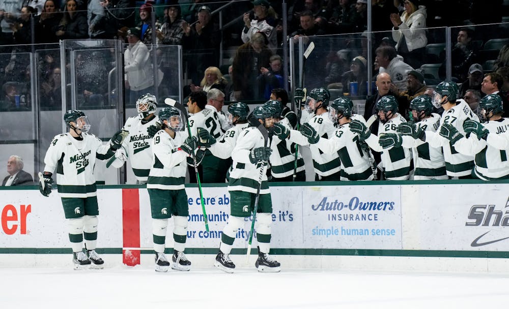 <p>The MSU men's hockey team high-five each other after scoring during a game against Notre Dame at Munn Ice Arena on Feb. 3, 2023. The Spartans defeated the Fighting Irish 3-0.</p>