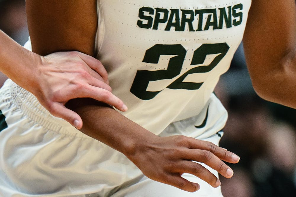 <p>DePaul sophomore guard Grace Carstensen (2) leans to take possession of the ball from Michigan State graduate student guard Nyla Hampton (22). The Spartans won 89-61 against the Blue Demons, starting the season 9-0 for the first time in program history.</p>