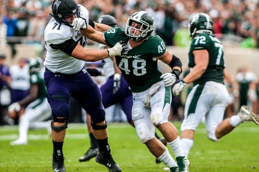 <p>Junior defensive end Kenny Willekes (48) collides with Northwestern&#x27;s senior lineman Tommy Doles (71) during the game against Northwestern on Oct. 6, 2018 at Spartan Stadium. The Wildcats led the Spartans, 14-6 at halftime. </p>