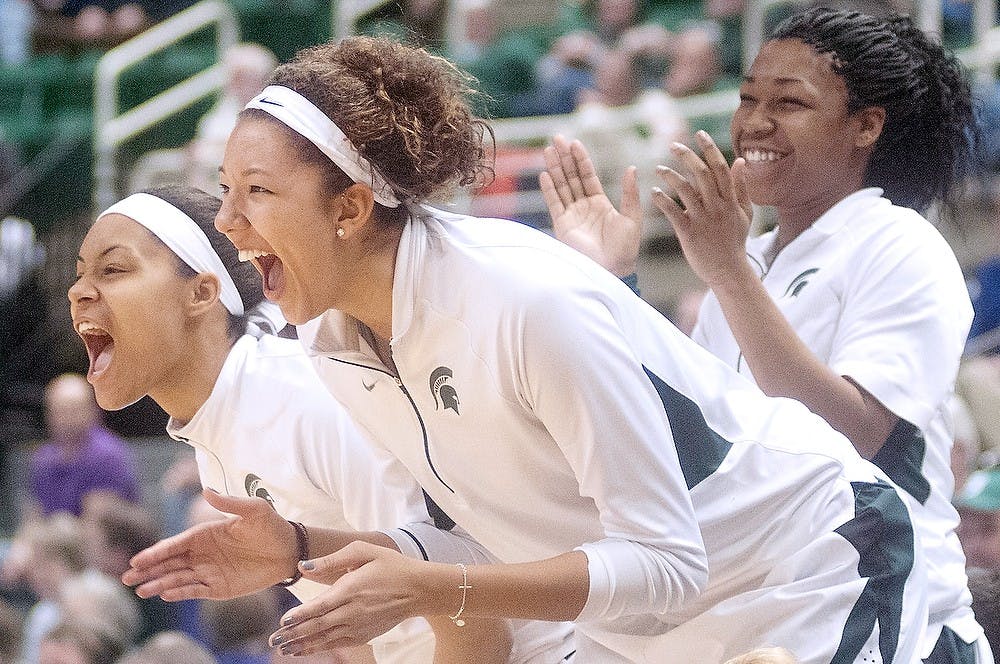 	<p>From left, freshman guard Mariah Harris, freshman forward Akyah Taylor and sophomore center Maddison Williams cheer from the sidelines during the game against Northwestern on Feb. 20, 2013, at Breslin Center. <span class="caps">MSU</span> beat Northwestern, 54-45. Danyelle Morrow/The State News</p>