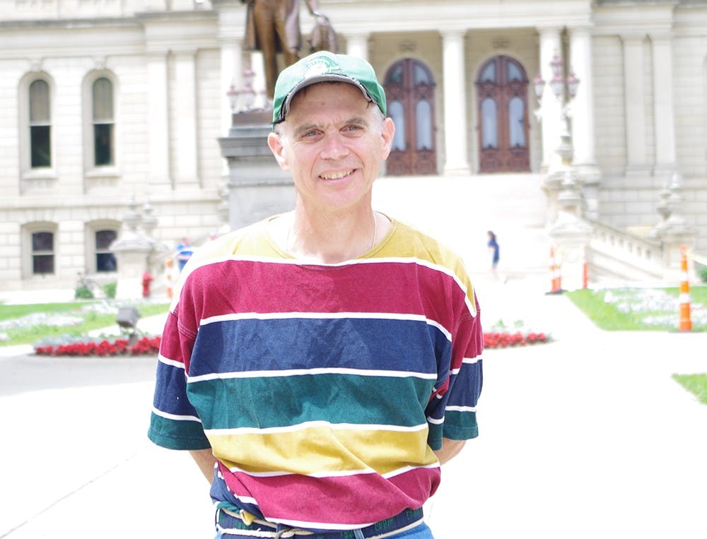 <p>Okemos resident Joe Palcucci, 63, stands in front of the State Capitol Building June 26, 2015. Yuanzhe Zhuang/The State News</p>