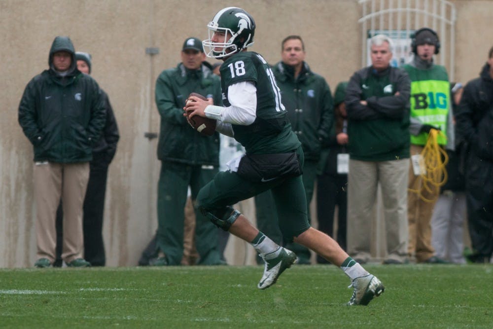 <p>Senior quarterback Connor Cook carries the ball during the fourth quarter of the Homecoming game against Purdue on Oct. 3, 2015, at Spartan Stadium. The Spartans defeated the Boilermakers, 24-21. </p>