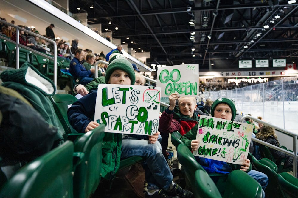 <p>Three young and potential future Spartans showcase their signs at their very first MSU Hockey game, which the Spartans went on to win 3-2 against Notre Dame on Feb. 4, 2023.</p>