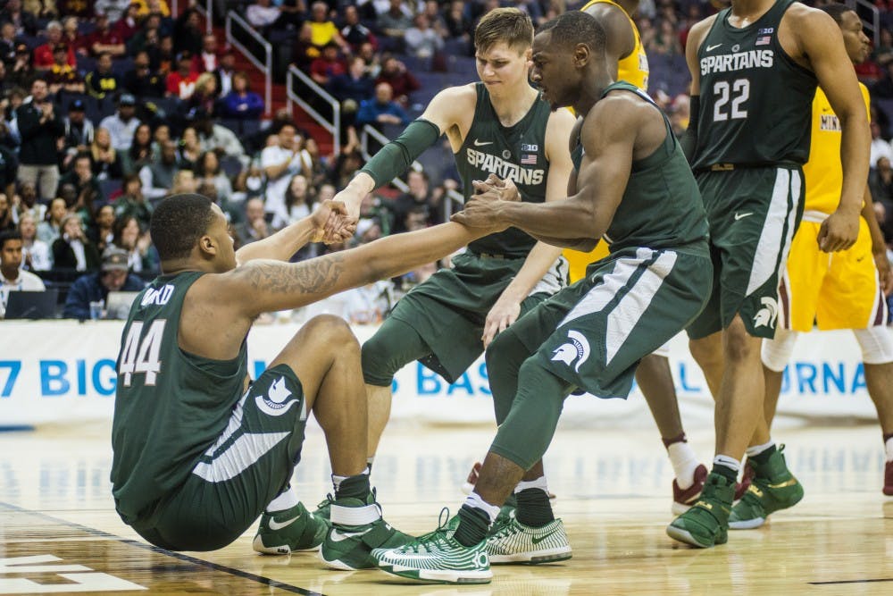Sophomore guard Matt McQuaid (20) and Junior guard Lourawls 'Tum Tum' Nairn Jr. (11) help freshman forward Nick Ward (44) during the second half of the game against Minnesota in the third round of the Big Ten Tournament on March 10, 2017 at Verizon Center in Washington D.C. The Spartans were defeated by the Golden Gophers, 63-58.