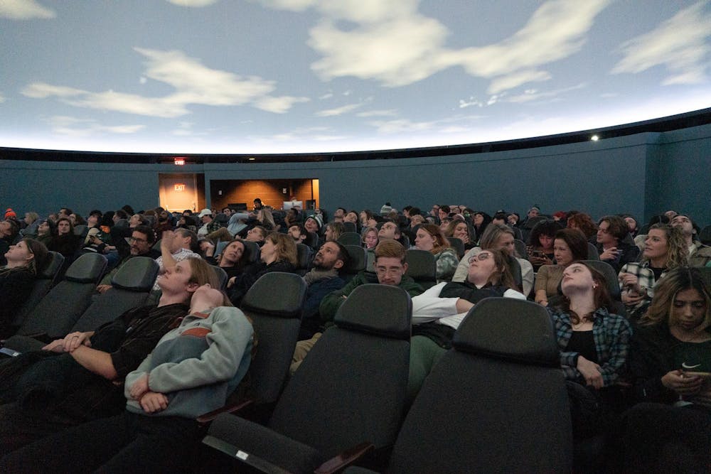 Students wait for the show to start at Abrams Planetarium on Friday, Nov. 10, 2023. The planetarium screened a show by British psychadelic rock band Pink Floyd, a visualization of their legendary 1973 album "Dark Side of the Moon" in celebration of the albums 50th birthday.