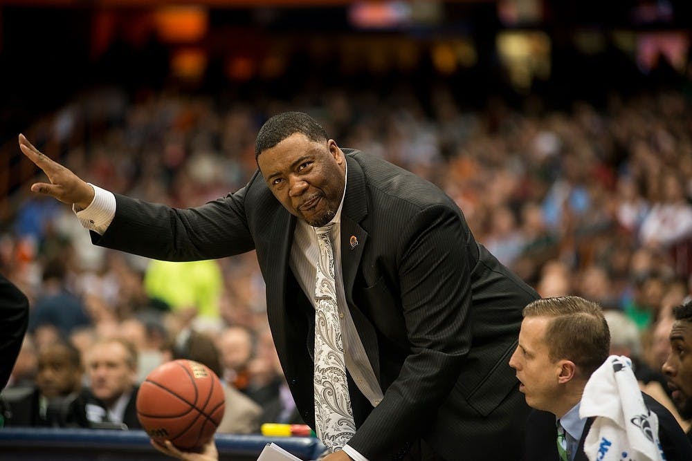 <p>Assistant head coach Dwayne Stephens jesters to his players March 27, 2015, during the East Regional round of the NCAA Tournament at the Carrier Dome in Syracuse, New York. The Spartans beat the Sooners, 62-58. (Erin Hampton | The State News)</p>