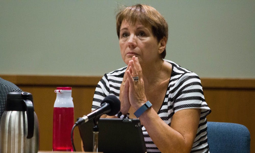 <p>East Lansing City Councilmember Susan Woods listens to the worries of residents on Sep. 12, 2017 at East Lansing City Hall on Linden Street. Woods was elected in November 2013.</p>