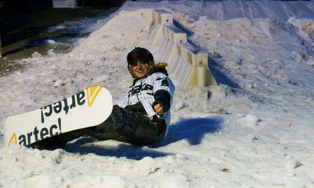 Business sophomore Sam Schowalter falls while attempting a trick on Feb. 10, 2017 at the rock on Farm Lane. The Spartan Ski Club hosted their annual Rail Jam event where participants competed for prizes.