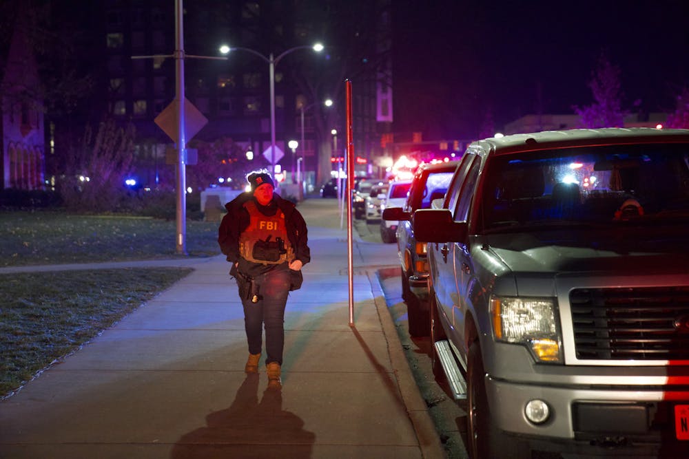 <p>Police run outside of the Union after an active shooting on Michigan State University's campus on Monday, Feb. 13, 2023.</p>