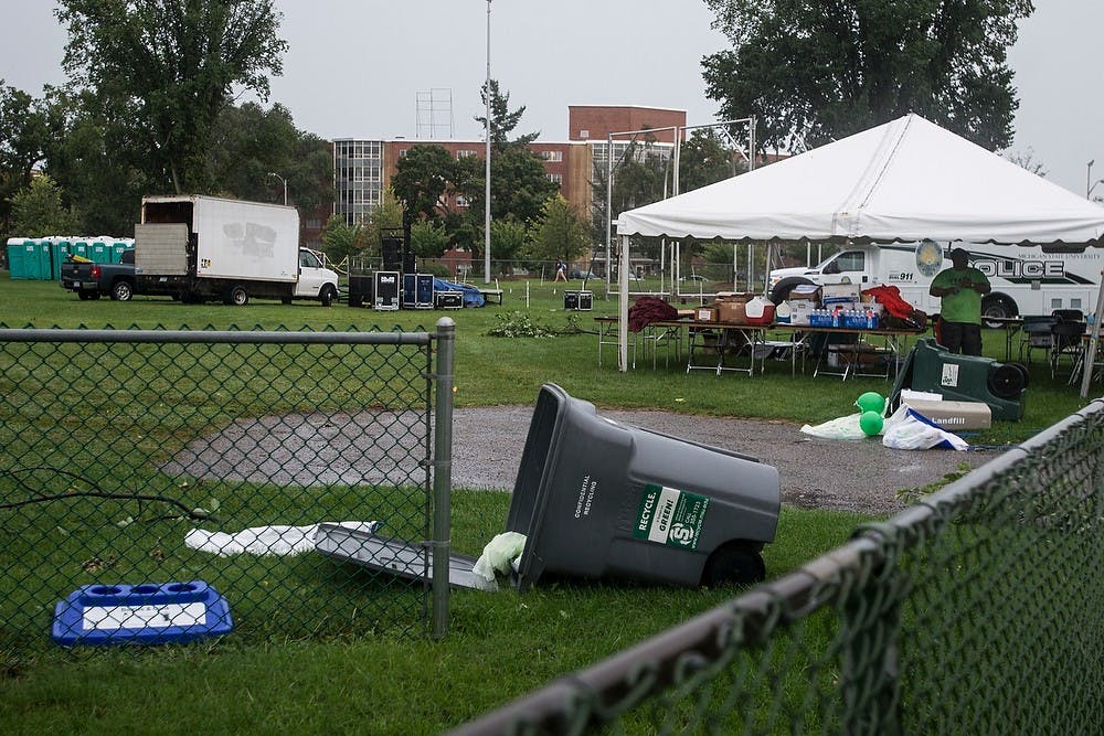 <p>Trash cans at Sparticipation lie on the ground after a severe thunderstorm Aug. 26, 2014, at Munn Field. Sparticipation was canceled due to the storm. Erin Hampton/The State News</p>