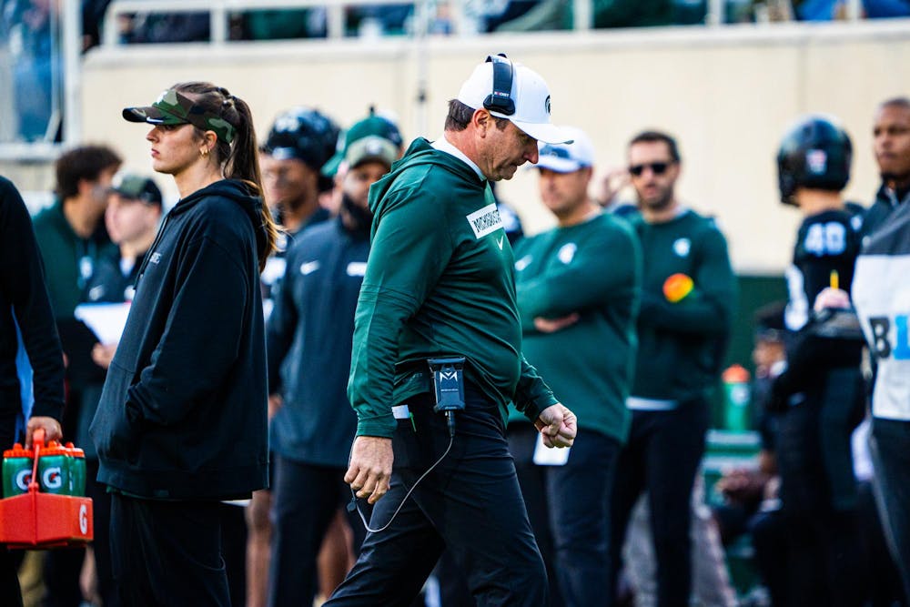 MSU Football head coach Jonathan Smith walks toward the sideline after a timeout huddle during a game at Spartan Stadium on Nov. 2, 2024.