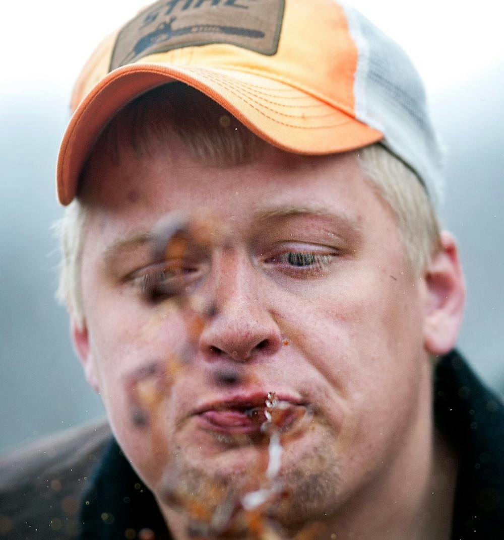 	<p>University of Wisconsin-Stevens Point student Erik Barttelt spit tobacco during a competition April 6, 2013 at the Ingham County Fairgrounds in Mason, Mich. The event hosted by <span class="caps">STIHL</span> Timbersports featured lumberjack events performed by both professional and collegiate competitors. Adam Toolin/The State News</p>