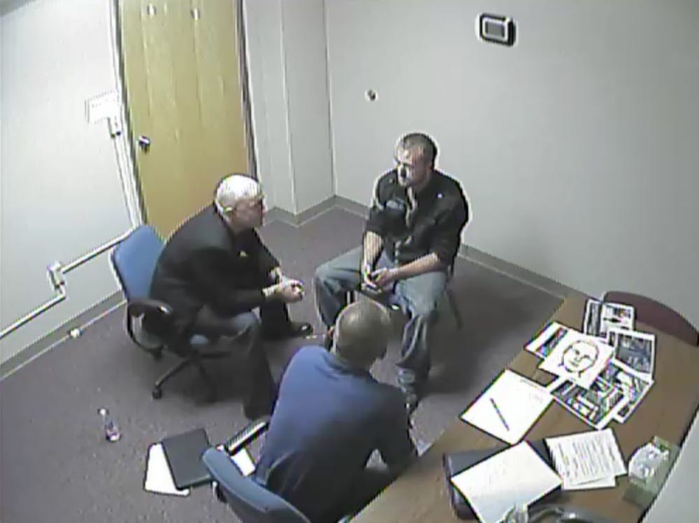 	<p>Oswald Scott Wilder, center, sits during his interrogation and eventual confession to East Lansing police regarding a series of sexual assaults earlier this year.</p>