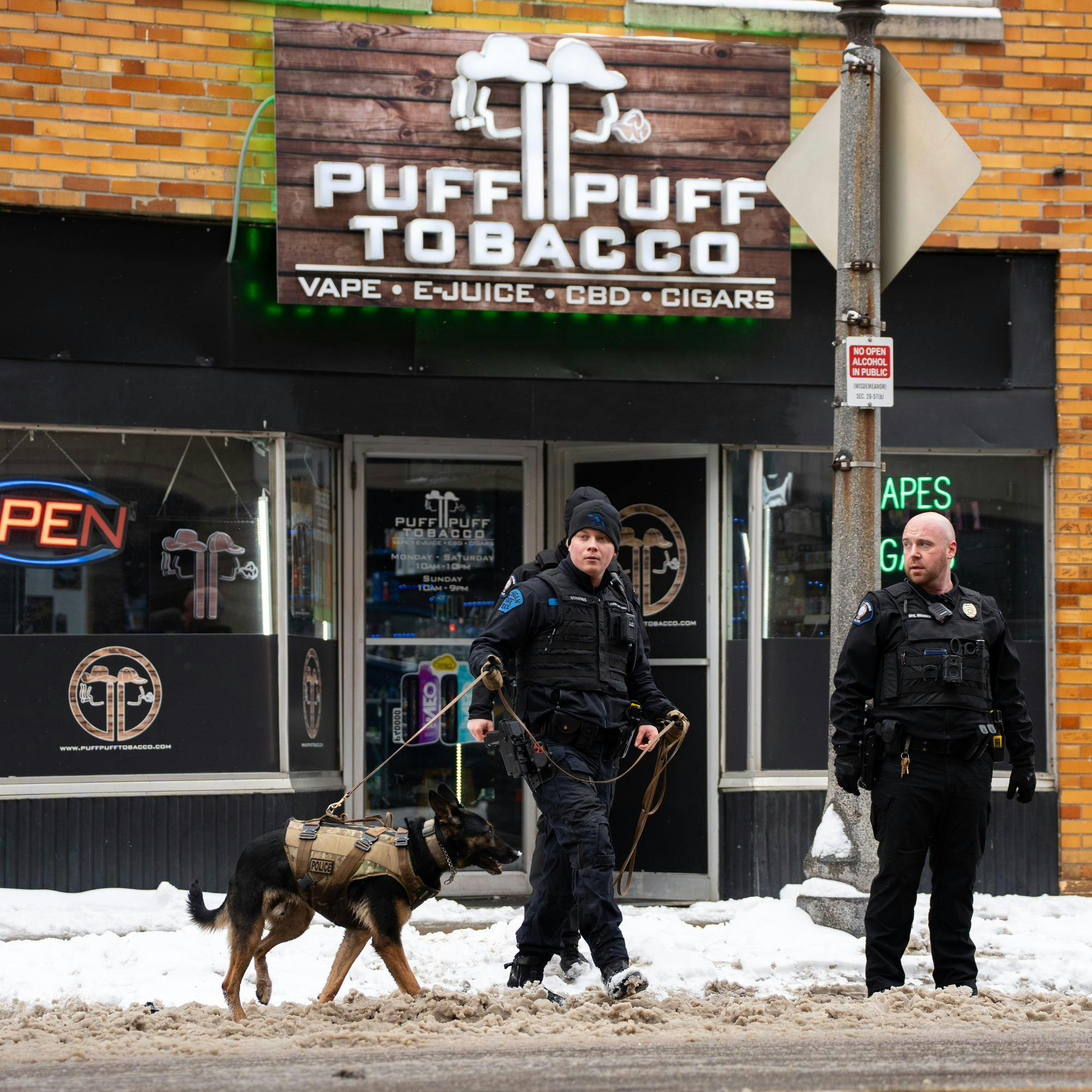 Police officers from the State Police Canine Unit and East Lansing Police respond to an armed robbery call inside of Puff Puff Tabacco on M.A.C. Ave. near Grand River in East Lansing, MI on Feb. 6, 2026.