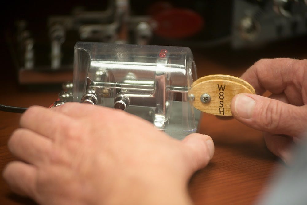 <p>W8SH radio club member Gregg Mulder communicates via Morse code March 24, 2014, at the Engineering Building with a friend in California. He said he can recognize his friend in California by the pace and speed of his Morse code. Julia Nagy/The State News</p>