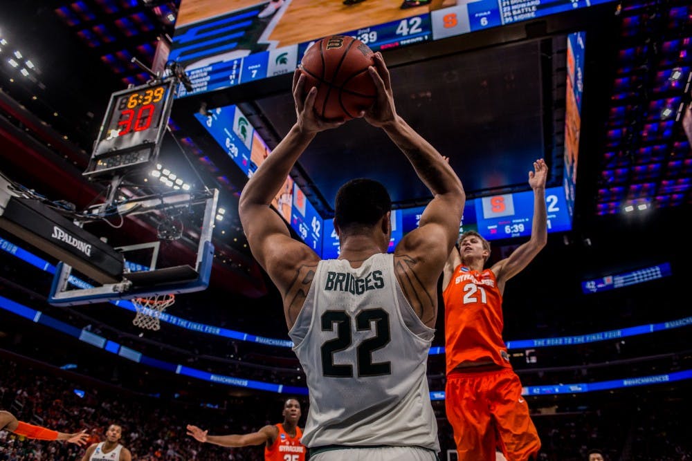 <p>Then-sophomore guard Miles Bridges (22) looks for a pass during the game against Syracuse on March 18, 2018, at Little Caesars Arena in Detroit. The Spartans fell to the Orange, 55-53, ending their NCAA journey.&nbsp;</p>