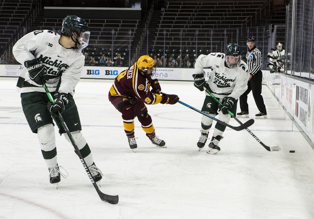 <p>Freshman forward A.J. Hodges (10) waits for teammate Charlie Combs (7) to pass him the puck in the first period. The Spartans fell to the Golden Gophers, 3-1, on Dec. 3, 2020.</p>