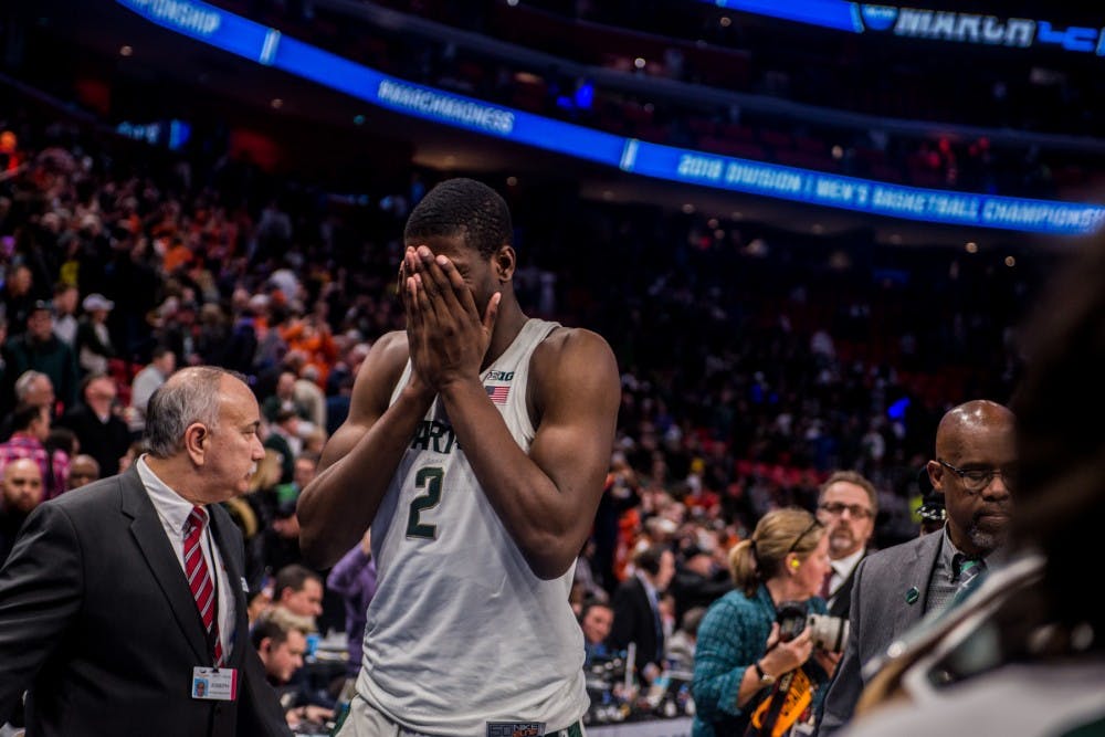 <p>Freshman forward Jaren Jackson Jr. (2) covers his face after the game against Syracuse on March 18, 2018 at Little Caesars Arena in Detroit. The Spartans fell to the Orange, 55-53 ending their NCAA journey.&nbsp;</p>