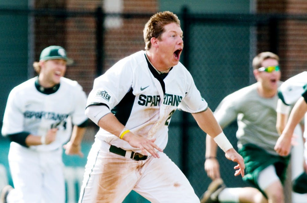 	<p>Sophomore outfielder Jared Hook rushes the field after the Spartans defeated Northwestern and claimed a share of the Big Ten Championship Friday afternoon at McLane Stadium. </p>