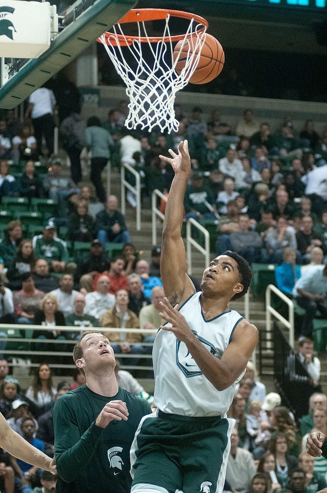 	<p>Sophomore guard Gary Harris goes up for a lay-up Oct. 18, 2013, during Midnight Madness at the Breslin Center. The men&#8217;s team scrimmaged against one another after the introductions. Julia Nagy/The State News</p>