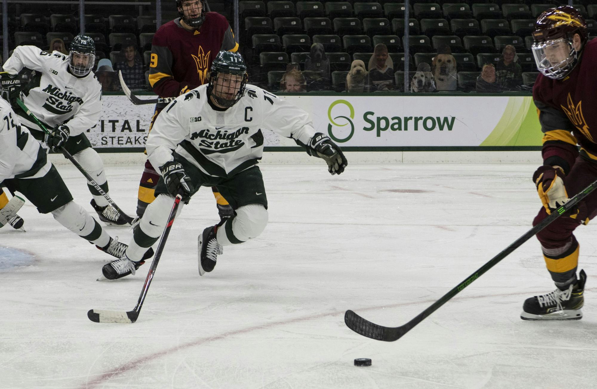 <p>Senior center Tommy Apap (11) charges an Arizona State player during the first period. The Spartans triumphed against the Sun Devils, 2-0, on Nov. 20, 2020.</p>