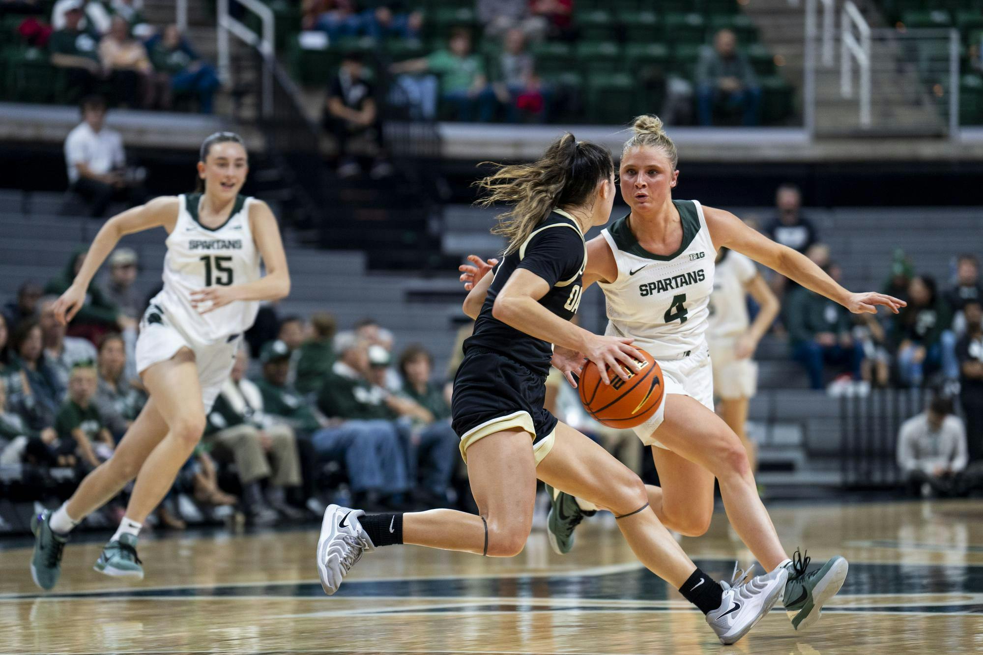 Michigan State University junior guard Theryn Hallock (4) guards an Oakland University player during the MSU vs. Oakland University women's basketball game at the Breslin Student Center on Nov. 5, 2024. 