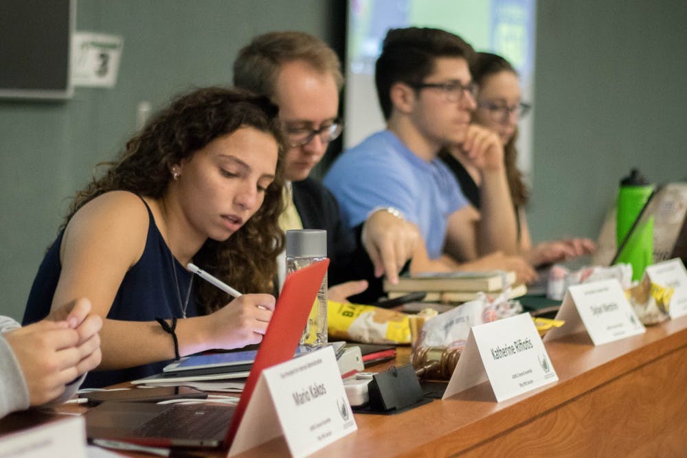 From left to right, ASMSU President Katherine “Cookie” Rifiotis, Vice President for Academic Affairs Dylan Westrin and Vice President for Finance and Operations Dan Iancio listen during the General Assembly Meeting at the International Center on Sept. 20, 2018. Rifiotis is the spokesperson for MSU’s undergraduate students.