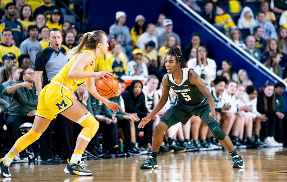 <p>Graduate student guard Kamaria McDaniel (5) guards a Michigan player during a game against Michigan at the Crisler Center on Jan. 14, 2023. The Spartans lost to the Wolverines 70-55. </p>