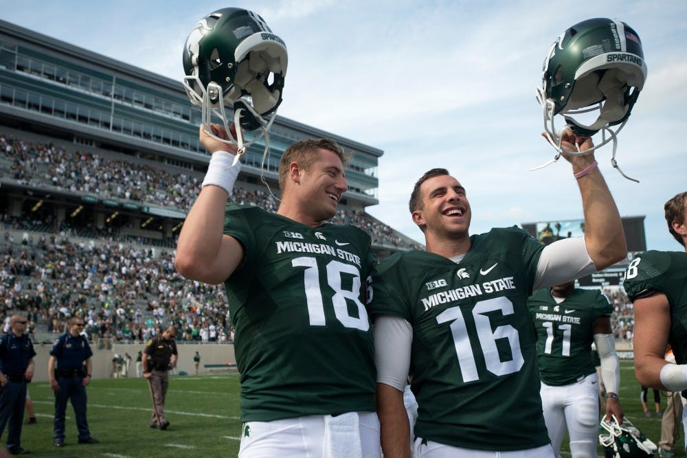 <p>Senior quarterback Connor Cook, 18, and senior quarterback Tommy Vento sing the fight song after the game against Central Michigan on Sept. 26, 2015, at Spartan Stadium. The Spartans defeated the Chippewas, 30-10. Julia Nagy/The State News </p>