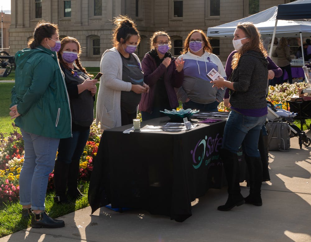 Participants of the State of Michigan Domestic Violence Rally speaking at booths on Thursday, October 1, 2020. (Di'Amond Moore)