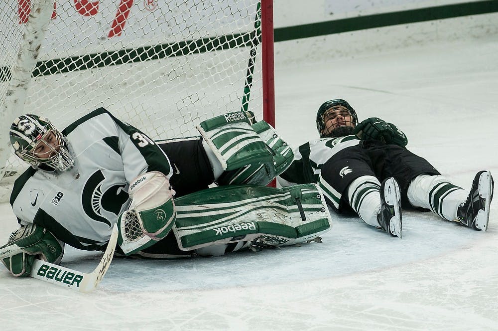 	<p>Sophomore goaltender Jake Hildebrand and senior defenseman Jake Chelios lay on the ice after giving up a goal during the game against Western Michigan on Nov. 22, 2013, at Munn Ice Arena. The Spartans lost to the Broncos, 2-0. Khoa Nguyen/The State News</p>