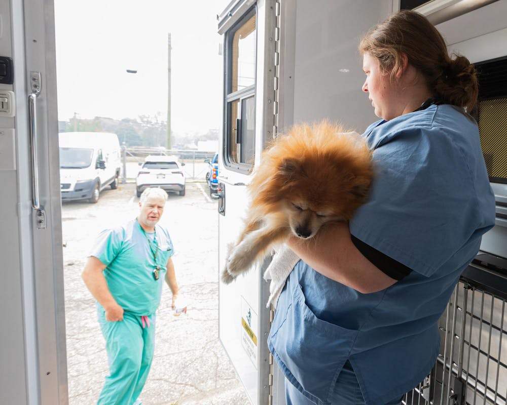 <p>Katlyn Cunningham carries Courage, a dog they just neutered, out of the MSU Veterinary Mobile Unit while waiting for him to wake up in Warren, Mich., on July 16, 2026.</p>