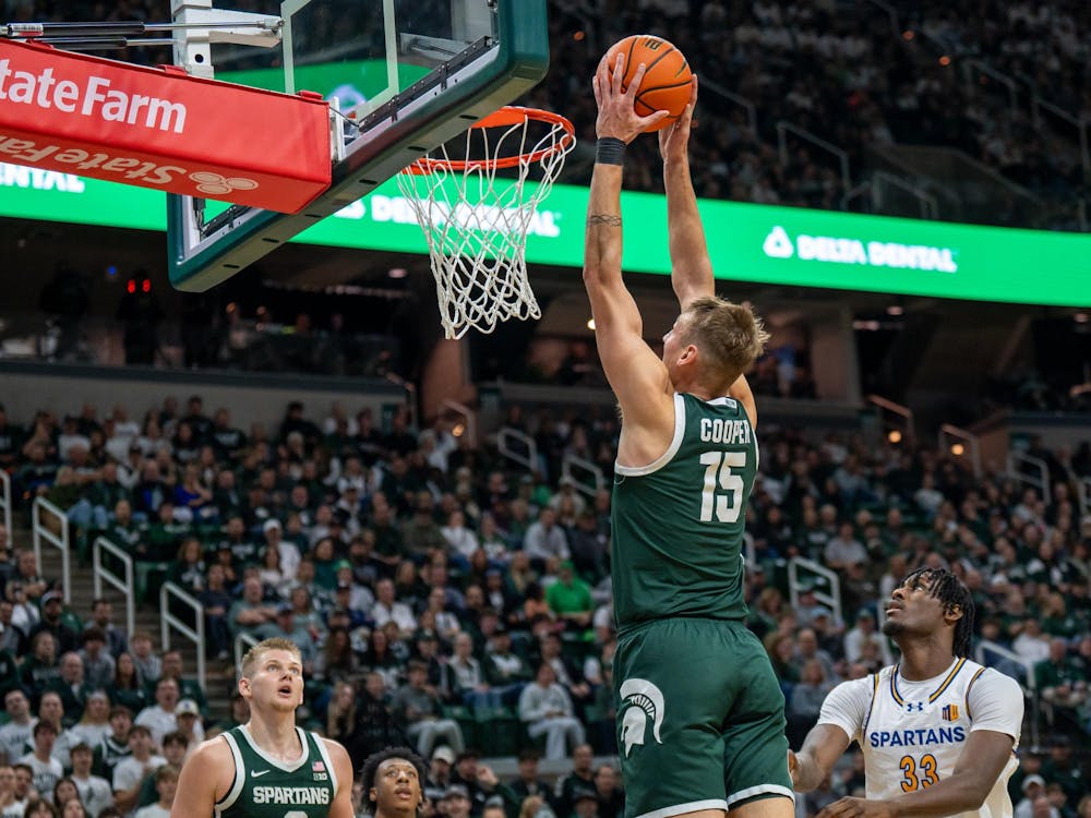 <p>MSU center and senior Carson Cooper (15) prepares to dunk the ball versus San José State at the Breslin Center in East Lansing, Michigan on Thursday, Nov. 13, 2025. </p>