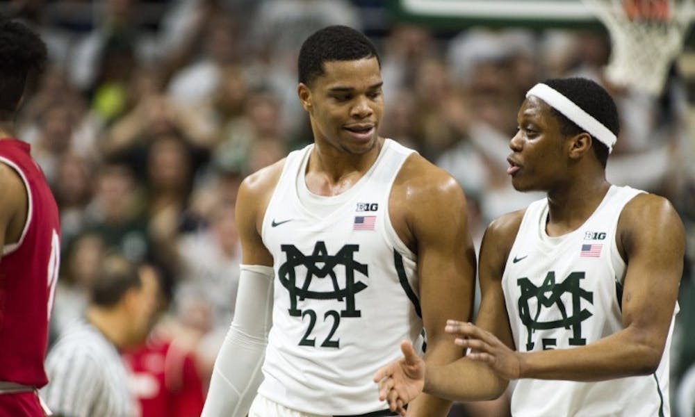 <p>Freshman guard/forward Miles Bridges (22) and freshman forward Cassius Winston (5) share a moment during the first half of men's basketball game against the University of Wisconsin on Feb. 26, 2017 at Breslin Center. The Spartans defeated the Badgers, 84-74.</p>