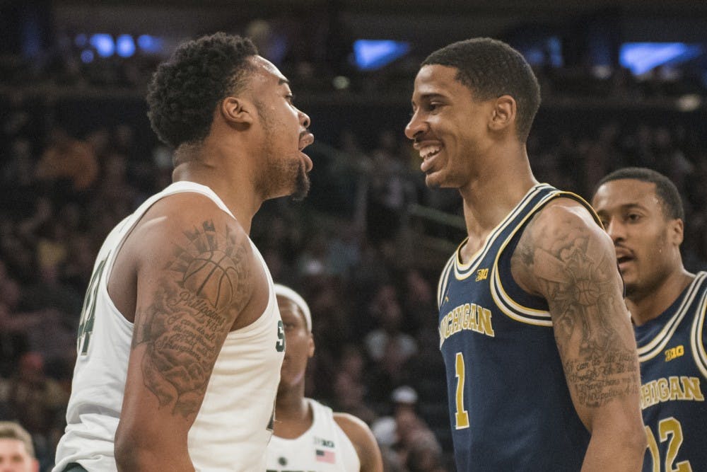 Sophomore forward Nick Ward (44) addresses Michigan guard Charles Matthews (1) during the first half of the 2018 Big Ten Men's Basketball semifinal game against Michigan on March 3, 2018 at Madison Square Garden in New York. (Nic Antaya | The State News)