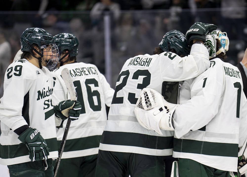 Michigan State University men’s hockey players celebrate with each other after defeating Notre Dame at their game in the Munn Ice Arena on Nov. 16, 2024. MSU won 4-3. 