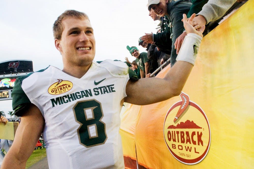 Senior quarterback Kirk Cousins celebrates with the Spartan fans. Cousins is the winninest quarterback in MSU history. The Spartans defeated the Georgia Bulldogs, 33-30, Monday afternoon at the Outback Bowl hosted in Raymond James Stadium at Tampa, Fla. after triple overtime. Justin Wan/The State News